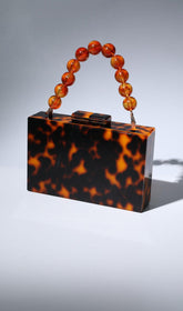 ACRYLIC BEADED CLUTCH IN AMBER