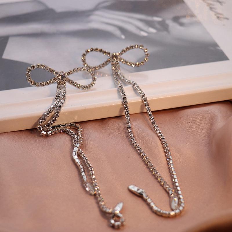 RHINESTONE BOW LONG CHAIN EARRINGS IN WHITE