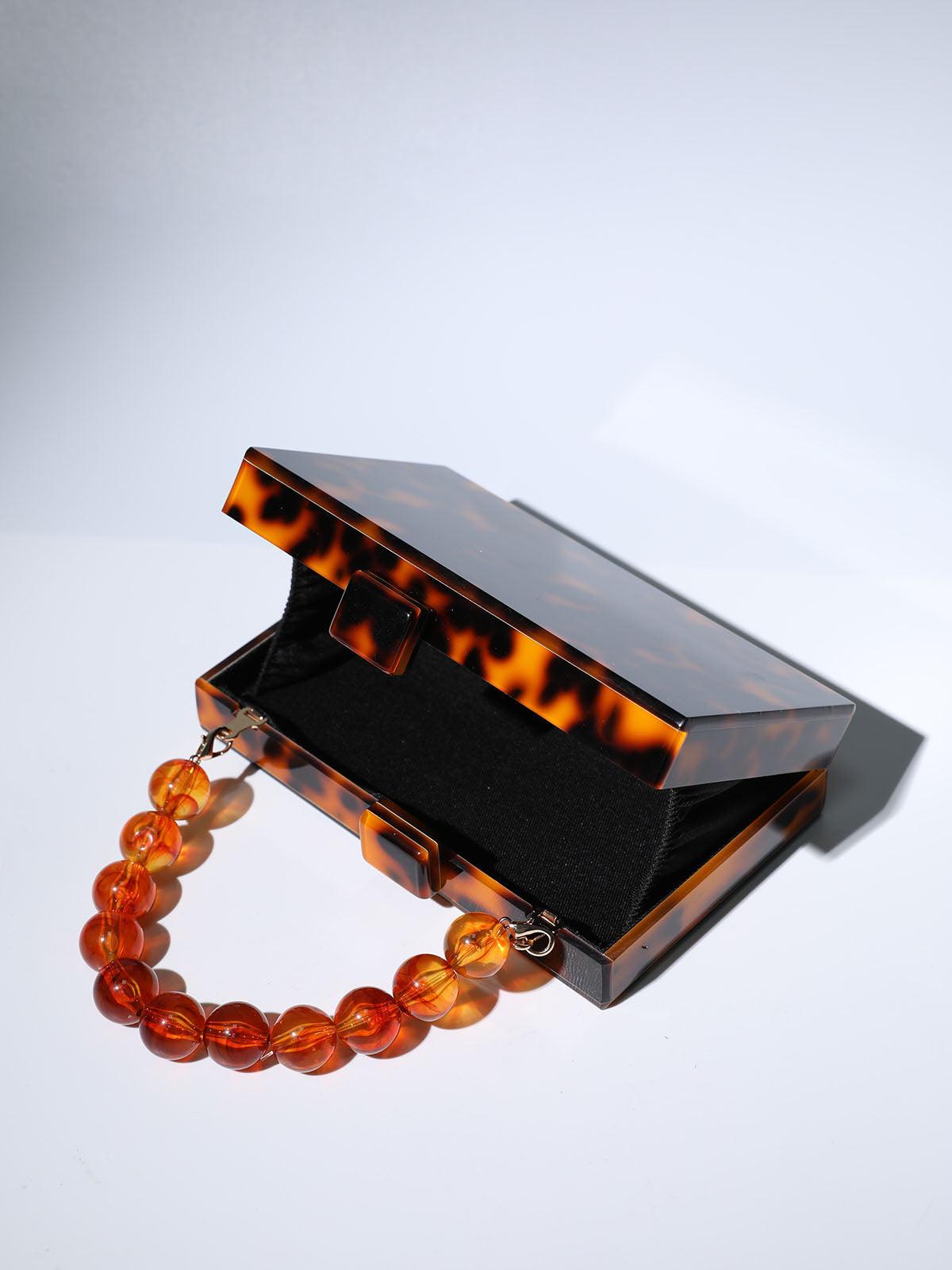 ACRYLIC BEADED CLUTCH IN AMBER